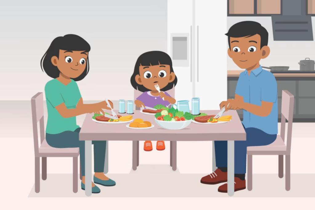 An illustration of a family sitting together at the dining table enjoying a meal. A mother, father, and young daughter are eating dinner that includes vegetables, salad, and water. The setting is a modern kitchen, and the family members look relaxed and happy.