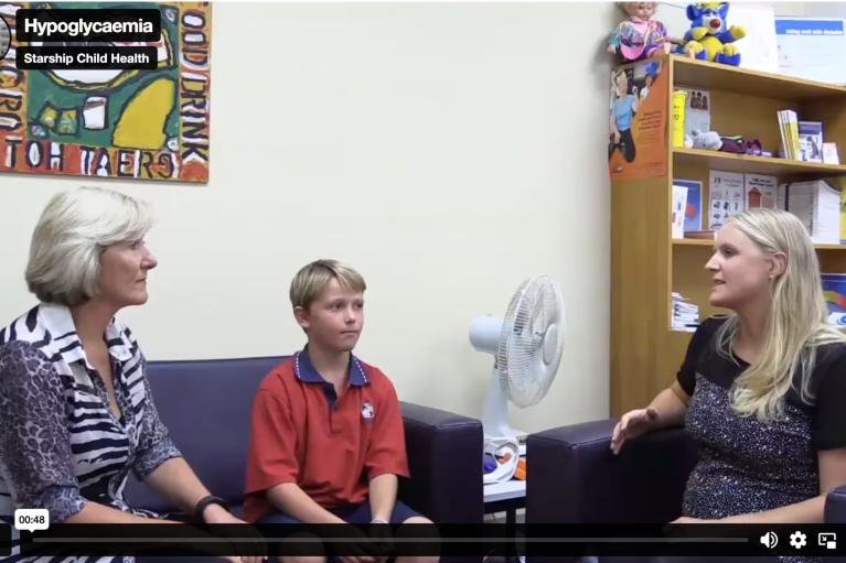 screenshot of a video by starship child health about hypoglycaemia featuring a mother and her son sitting on a couch next to a female health professional