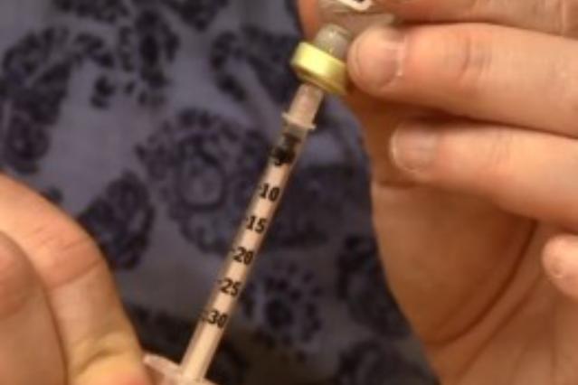 Glucagon with needle being drawn into syringe