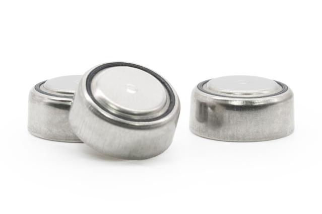 A photograph of 3 small button batteries