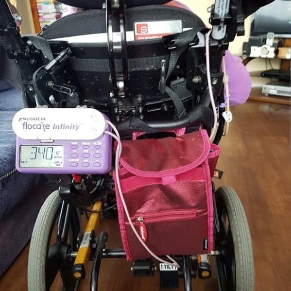 Adapting a bag to attach tube feeding equipment to a wheelchair. 