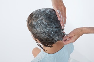 Applying conditioner to a child's hair