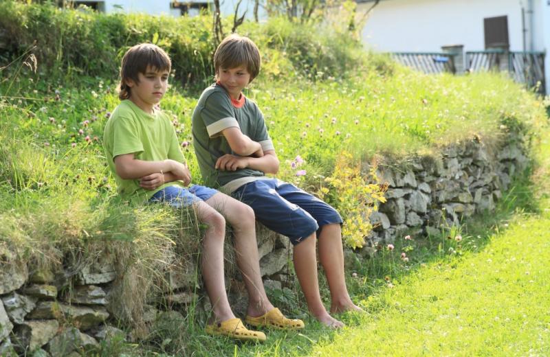 2 brothers sitting on a wall