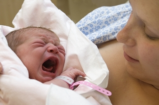 Mother holding her crying baby