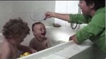 Video thumbnail image showing 2 children in bath and mum pouring water over one child's head