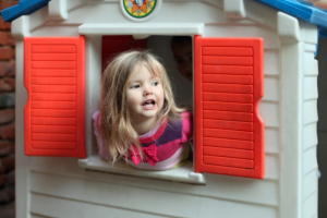 Child playing in a playhouse